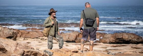 2 men talking on the rocks of West Coast